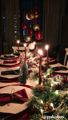 a christmas table setting with candles and decorations