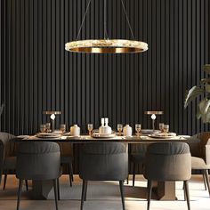 an elegant dining room with black walls and wooden table surrounded by grey chairs, gold chandelier