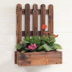 a wooden planter with flowers in it