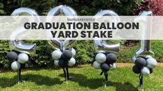 graduation balloon yard stakes with the words graduation balloon yard stake in front of them