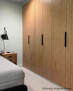 a bedroom with wooden closets and white carpet