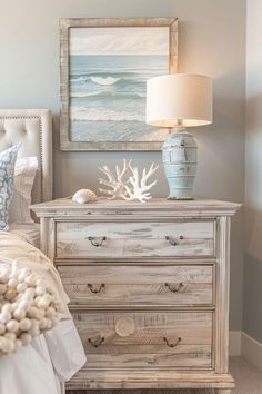 a bed room with a neatly made bed and a painting on the wall above it