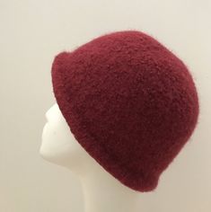 a white mannequin head wearing a red hat