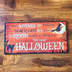 a wooden sign that says witches go riding the moon laughs & whisperss it's near halloween