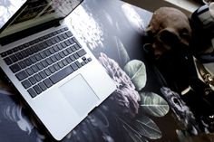 an open laptop computer sitting on top of a table next to a cup of coffee