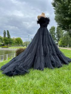 a black dress is on display in the grass