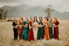 a group of women standing next to each other in a field