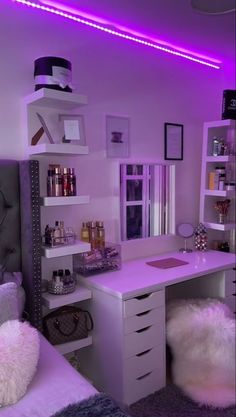 a bedroom with purple lighting in the corner and shelves on the wall above the desk