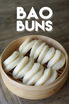 the buns are ready to be eaten in the steamer basket on the wooden table