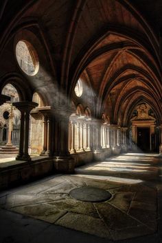 sunlight shining through the windows into an old building with stone arches and arched doorways