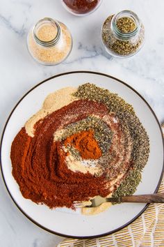 a white plate topped with spices and seasonings