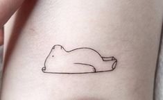 a woman's leg with a small tattoo of a polar bear on the side