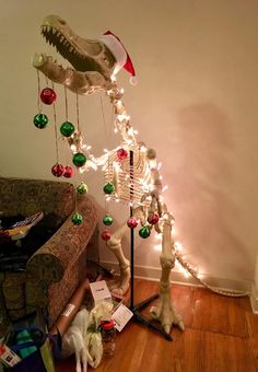 a living room filled with furniture and christmas decorations on the floor next to a couch