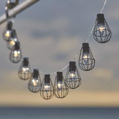 several light bulbs hanging from a metal pole