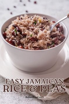 a white bowl filled with rice and beans on top of a plate next to a fork