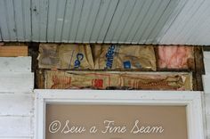 there is a sign that says sew a fine seam on the side of a house