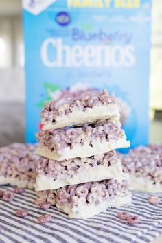 three blueberry cheesecakes stacked on top of each other next to a bag of cereal