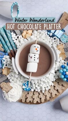 hot chocolate platter with marshmallows and snowmen on it