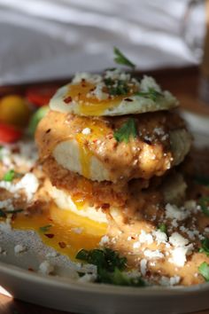 a white plate topped with food on top of a wooden table