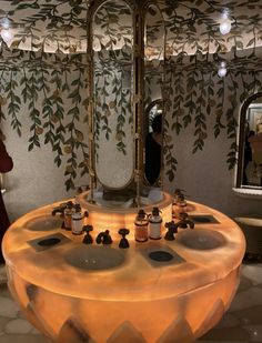 a round table with candles on it in front of a mirror and some people looking at it