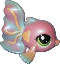 a pink toy fish with big eyes on it's side