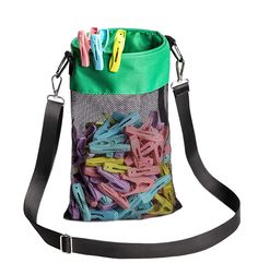 a bag filled with lots of different colored paper clips and some black strap around it