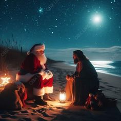 two people dressed as santa claus and sitting on the beach at night with stars in the sky