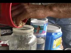 a man is pouring something into a jar