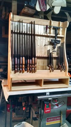 a wooden bench with many different types of knives on it