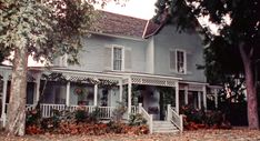 an old house with white trim and porches