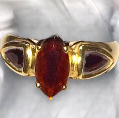 BEAUTIFUL 14K YELLOW GOLD GARNET COCKTAIL RING Beautiful ring in excellent condition! * .75 carat center Marquis garnet, with 2 - .20 carat pear shaped garnets set on the sides. * Size 6  * Weighs 2.7 grams Shipped FAST AND FREE, fully insured and gift boxed :) I guarantee item to be exactly as described and pictured. Black Opal Pendant, Garnet Gem, Red Band, Black Gift Boxes, Cute Rings, Beautiful Ring, Multi Stone Ring, Opal Pendants, Black Opal