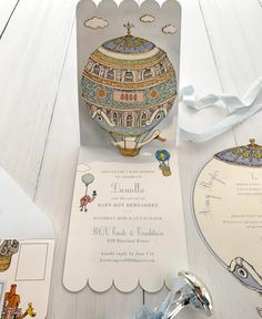 a paper card with an ornament on it next to other cards and decorations