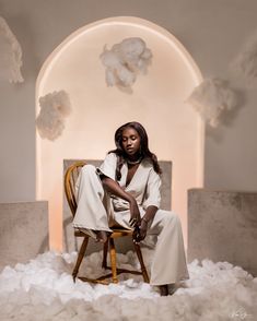 a woman is sitting in a chair surrounded by foams and cotton bouncy