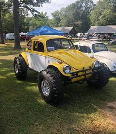 a yellow and white buggy parked in the grass