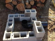 cinder blocks are arranged in the shape of a square and rectangled fire pit