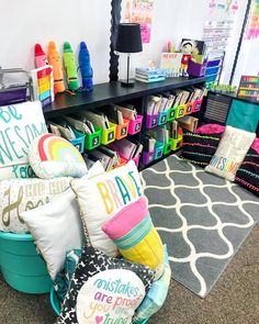 a room filled with lots of colorful pillows and other items on the floor in front of a black table