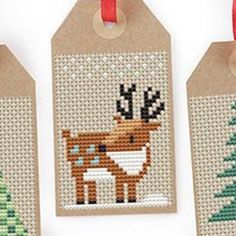 three christmas tags with deer and pine trees on them