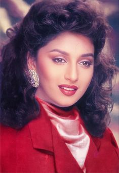 an old photo of a woman wearing a red suit and earrings with her hair in curls