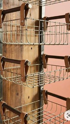 a wall mounted metal shelf with several hooks on the bottom and one hanging from it's sides