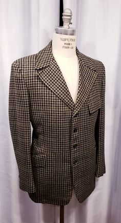 Beautiful houndstooth cloth two piece suit probably made in the 70's but exceptional quality. With the proper accessories it would be hard to tell this is not a true period piece, but the next best thing. Ready for the Dickens Faire or a period holiday party. Inside label reads: Mike Bain Inside pocket still has the Amalgamated Union Tag made in the USA the United States of America. Coat measures: Shoulders 18 1/2 inches, Chest 45 inches, sleeves 25 inches and length is 31 inches. Pants measure: Semi-formal Tweed Jacket With Houndstooth Pattern And Suit Collar, Semi-formal Houndstooth Tweed Jacket With Suit Collar, Semi-formal Tweed Jacket With Houndstooth Pattern, Semi-formal Houndstooth Tweed Jacket, Fitted Black Tweed Jacket With Houndstooth Pattern, Black Houndstooth Tweed Jacket For Formal Occasions, Vintage Tweed Suit For Formal Occasions, Fitted Houndstooth Suits For Fall, Retro Notch Lapel Tweed Jacket For Formal Occasions