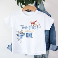 a t - shirt that says time flies and now i'm one