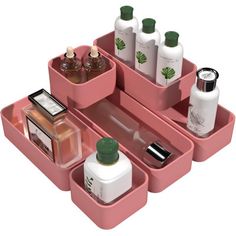 a pink tray with three compartments holding cosmetics and personal care items