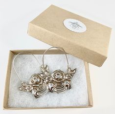 "These earrings are made from a vintage silver dish which had a beautiful embossed around the edge of flowers and other art nouveau motifs. I followed the line of the pattern into a point, drilled it and attached a sterling silver ear wire which is attached to either side of the charm. One side is hooked and unloops from the other side for you to insert the ear wire, and then clip it back up. They are very lightweight but are so eye catching. Measurements: Charm Length: 53 mm / 2.08\" Charm Widt Vintage Small Hoop Jewelry Gift, Silver Engraved Hoop Earrings For Gift, Engraved Small Hoop Earrings As Gift, Engraved Small Hoop Earrings For Gift, Vintage Metal Hoop Earrings As Gift, Vintage Hoop Earrings With Lever Back For Gifts, Vintage Silver Hoop Earrings For Wedding, Vintage Nickel-free Hoop Earrings For Gift, Ornate Metal Hoop Earrings Gift