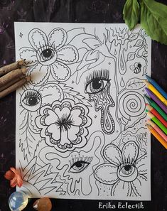 an adult coloring book with flowers and butterflies on it, next to colored pencils