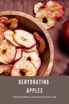 a wooden bowl filled with sliced apples on top of a table