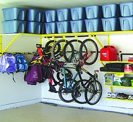 there is a bike hanging on the wall next to some shelves with bins and cups