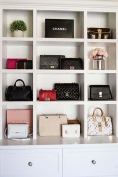 a white bookcase filled with lots of purses and handbags on top of it