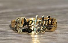 The Debbie: Ladies 14K Yellow Gold Debbie Name Ring. Crafted in 14 karat yellow gold, this trendy name ring displays the name Debbie. The perfect gift for the lady who has everything. Currently a finger size 5.75, this ring can be resized for an additional charge. Each piece has been hand selected and meticulously identified and graded by a Graduate Gemologist who has been awarded a degree by the Gemological Institute of America (GIA). Please visit our Shop's About Page or our website for more i Elegant Yellow Gold Nameplate Ring, Elegant Gold Nameplate Engraved Ring, Elegant Gold Engraved Nameplate Ring, Classic Gold Rings With Names, Gold Nameplate Rings With Names, Elegant Yellow Gold Engraved Ring With Custom Name, Elegant Nameplate Rings, Elegant Custom Name Engraved Yellow Gold Ring, 14k Gold Engraved Ring With Names