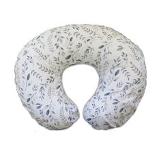 the neck pillow is white with leaves on it