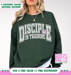 a woman wearing a green sweatshirt with the words,'disseple in training'on it